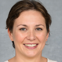 Joyful white adult female with medium  brown hair and brown eyes