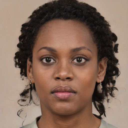Neutral black young-adult female with long  brown hair and brown eyes