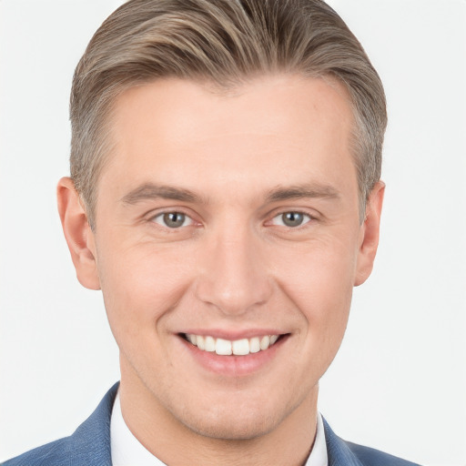 Joyful white young-adult male with short  brown hair and grey eyes