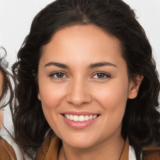 Joyful white young-adult female with long  brown hair and brown eyes