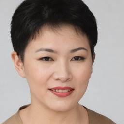 Joyful asian young-adult female with short  brown hair and brown eyes