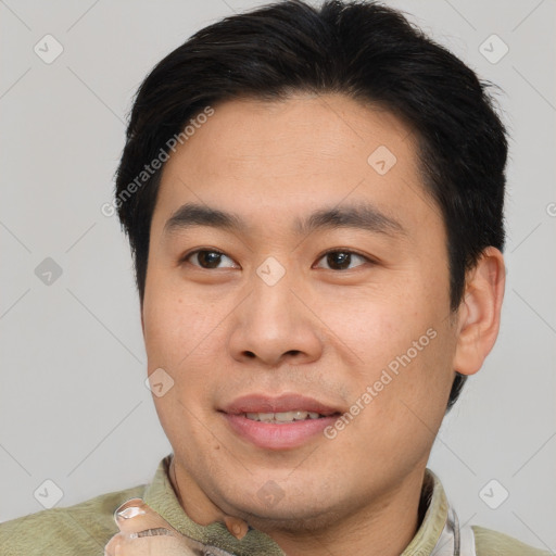 Joyful asian young-adult male with short  brown hair and brown eyes