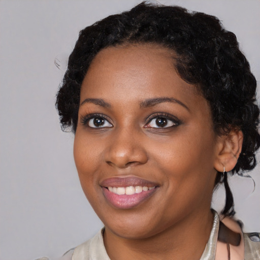 Joyful black young-adult female with medium  black hair and brown eyes