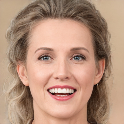 Joyful white young-adult female with medium  brown hair and green eyes