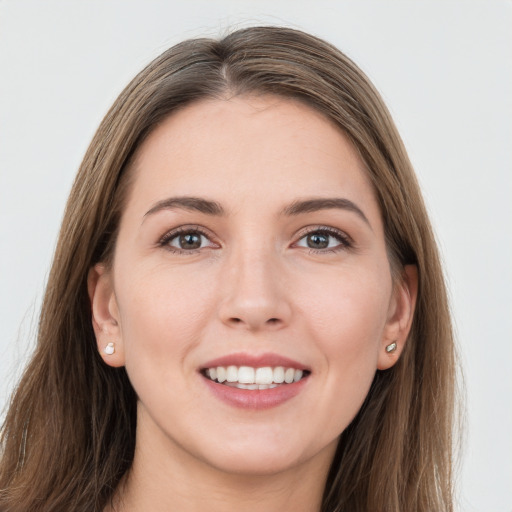 Joyful white young-adult female with long  brown hair and grey eyes