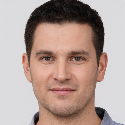 Joyful white young-adult male with short  brown hair and brown eyes