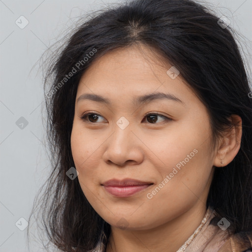 Joyful asian young-adult female with long  brown hair and brown eyes