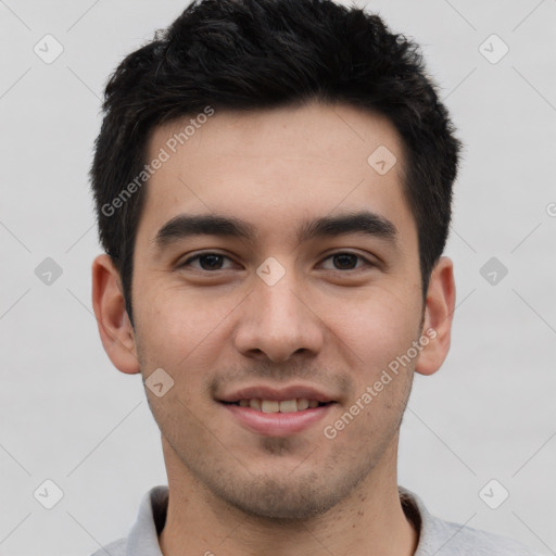 Joyful white young-adult male with short  black hair and brown eyes