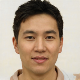 Joyful asian young-adult male with short  brown hair and brown eyes