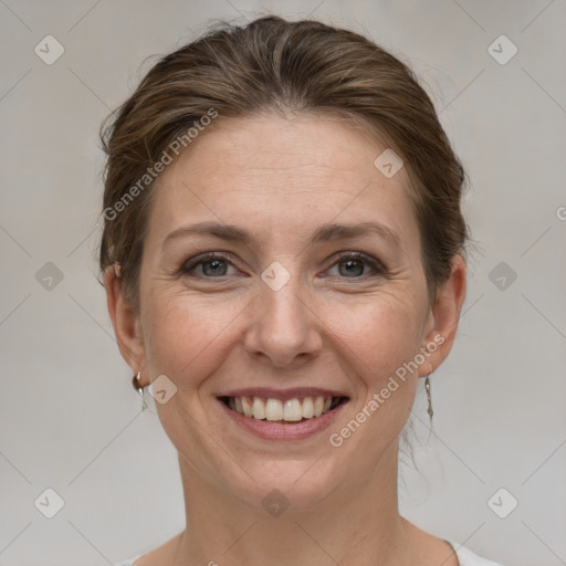 Joyful white adult female with short  brown hair and grey eyes