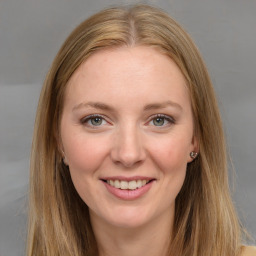 Joyful white young-adult female with long  brown hair and grey eyes