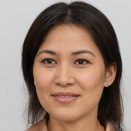 Joyful asian young-adult female with medium  brown hair and brown eyes