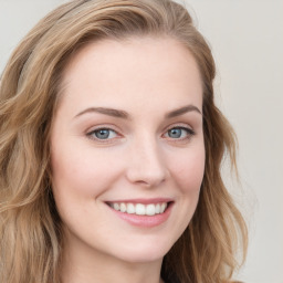 Joyful white young-adult female with long  brown hair and blue eyes