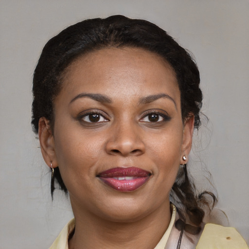 Joyful black young-adult female with medium  brown hair and brown eyes