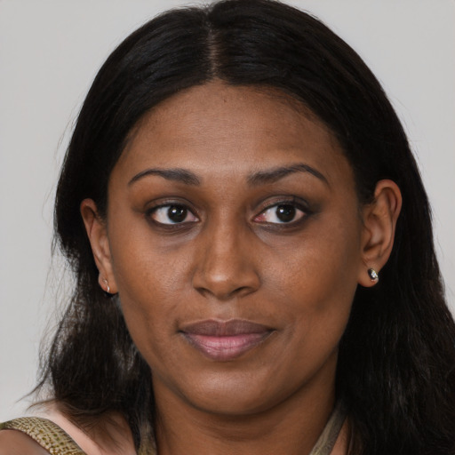 Joyful latino adult female with medium  brown hair and brown eyes