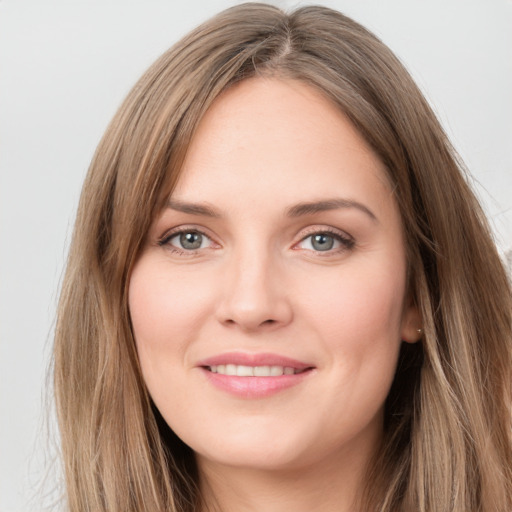 Joyful white young-adult female with long  brown hair and green eyes