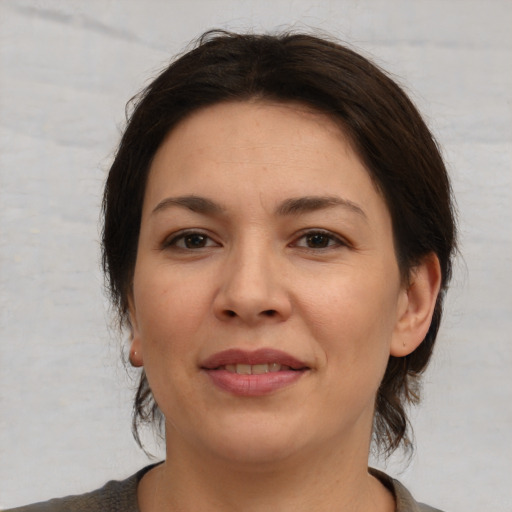 Joyful white young-adult female with medium  brown hair and brown eyes