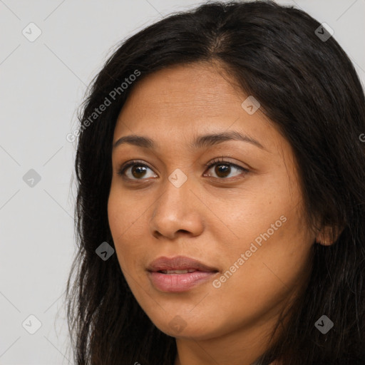 Joyful latino young-adult female with long  brown hair and brown eyes