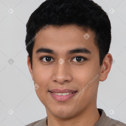 Joyful latino young-adult male with short  brown hair and brown eyes