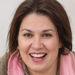 Joyful white adult female with long  brown hair and brown eyes