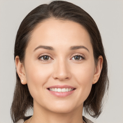 Joyful white young-adult female with medium  brown hair and brown eyes