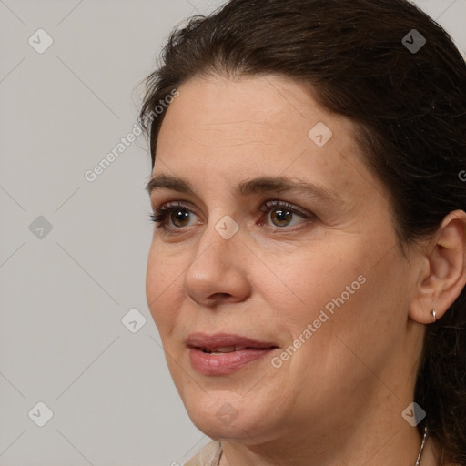 Joyful white adult female with medium  brown hair and brown eyes