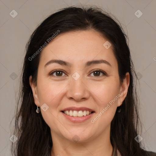 Joyful white adult female with long  brown hair and brown eyes