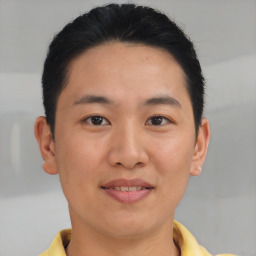 Joyful asian young-adult male with short  brown hair and brown eyes