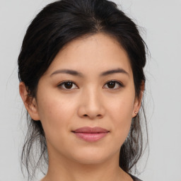 Joyful asian young-adult female with medium  brown hair and brown eyes