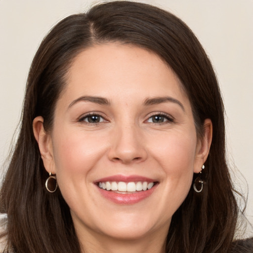 Joyful white young-adult female with long  brown hair and brown eyes