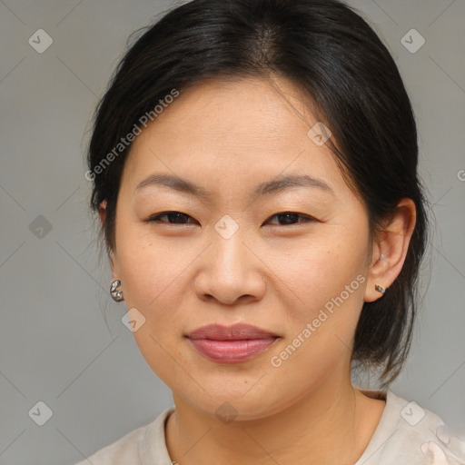 Joyful asian adult female with medium  brown hair and brown eyes