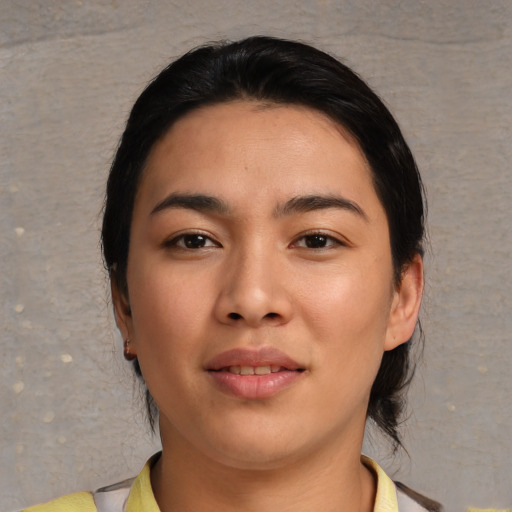 Joyful asian young-adult female with medium  black hair and brown eyes