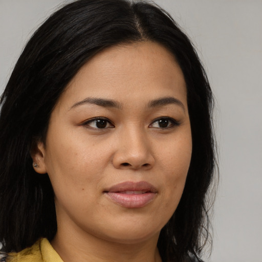 Joyful asian young-adult female with long  brown hair and brown eyes