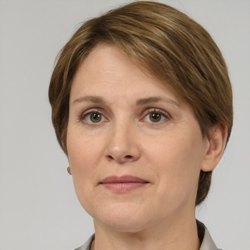 Joyful white adult female with medium  brown hair and grey eyes