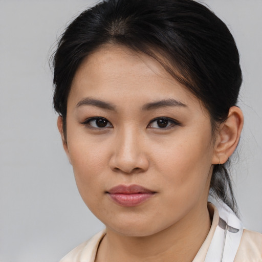 Joyful asian young-adult female with medium  brown hair and brown eyes