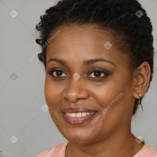 Joyful black young-adult female with short  brown hair and brown eyes