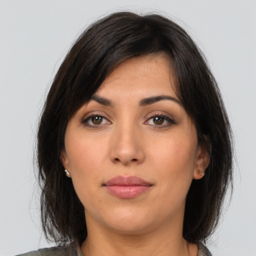 Neutral latino young-adult female with medium  brown hair and brown eyes