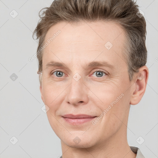 Joyful white adult male with short  brown hair and grey eyes