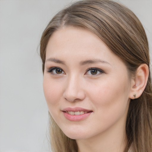 Joyful white young-adult female with long  brown hair and grey eyes