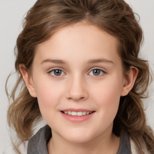 Joyful white child female with medium  brown hair and brown eyes