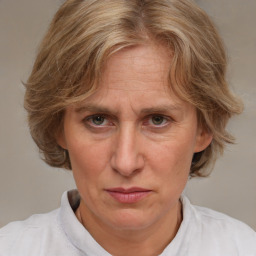 Joyful white adult female with medium  brown hair and blue eyes