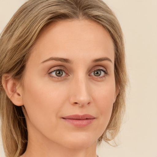 Joyful white young-adult female with long  brown hair and green eyes