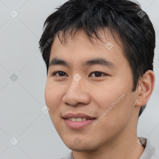 Joyful asian young-adult male with short  black hair and brown eyes