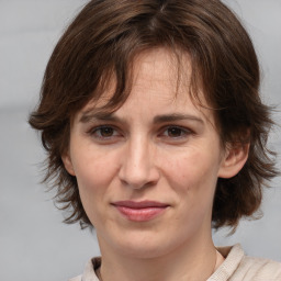 Joyful white adult female with medium  brown hair and brown eyes