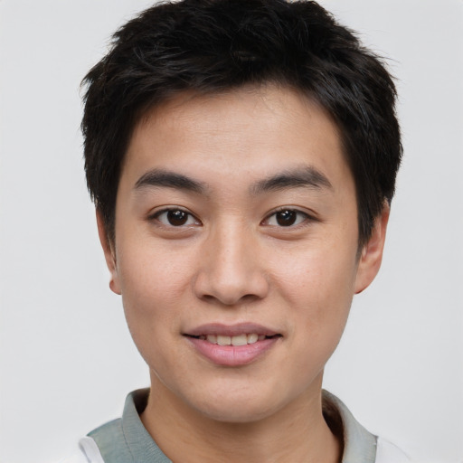 Joyful asian young-adult male with short  brown hair and brown eyes