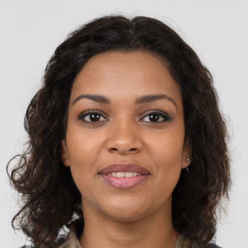 Joyful black young-adult female with medium  brown hair and brown eyes