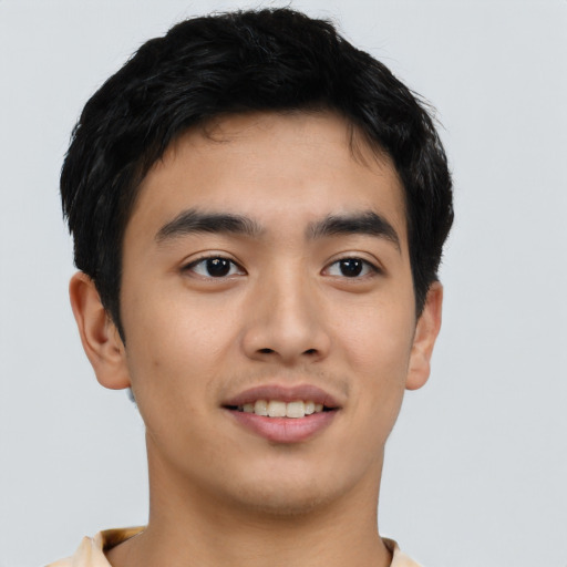 Joyful asian young-adult male with short  black hair and brown eyes