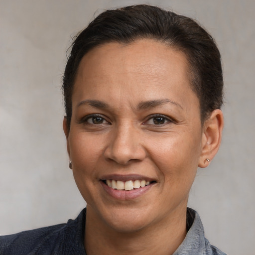 Joyful white adult female with short  brown hair and brown eyes