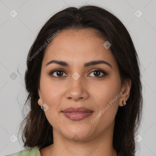 Joyful latino young-adult female with long  brown hair and brown eyes