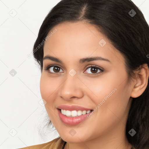 Joyful latino young-adult female with long  brown hair and brown eyes